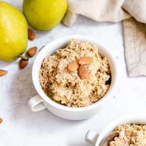 A bowl of ginger pear muesli, garnished with almonds.