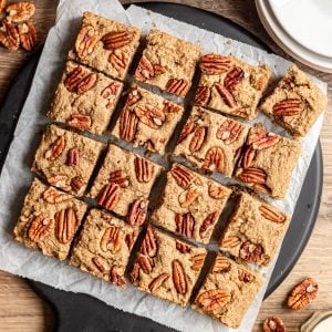 A tray of maple pecan blondies, cut into squares.