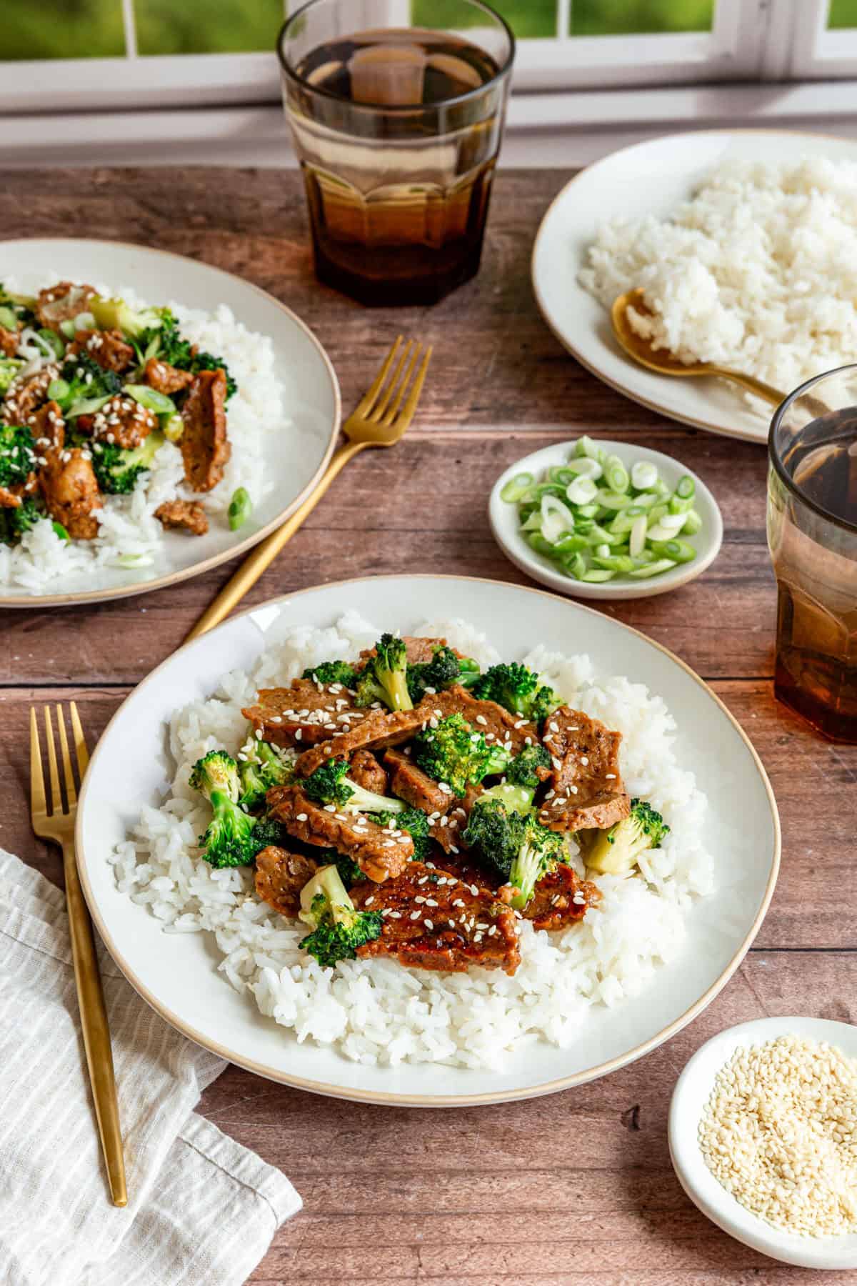 Several plates of teriyaki seitan, and a plate of rice.