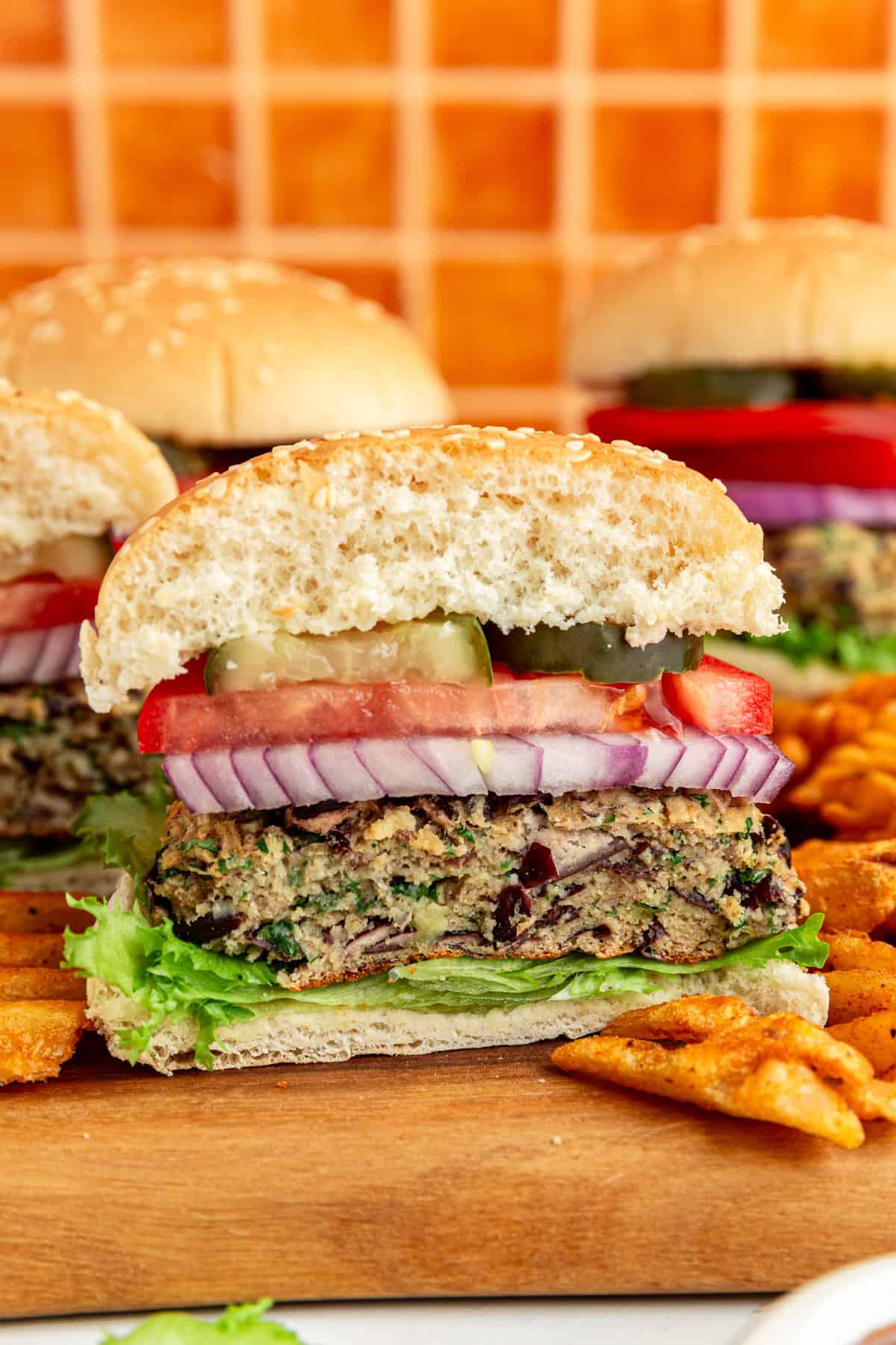 A Vegan Kidney Bean Burger assembled and sliced in half to show the moist burger texture.