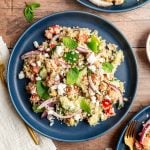 A plate of vegan mediterranean quinoa salad.