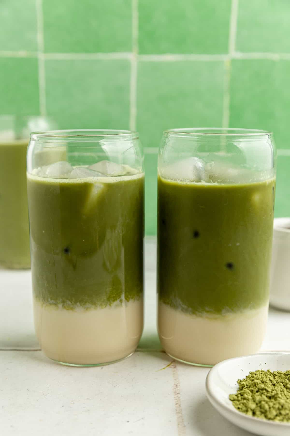 Two glasses filled with iced matcha.