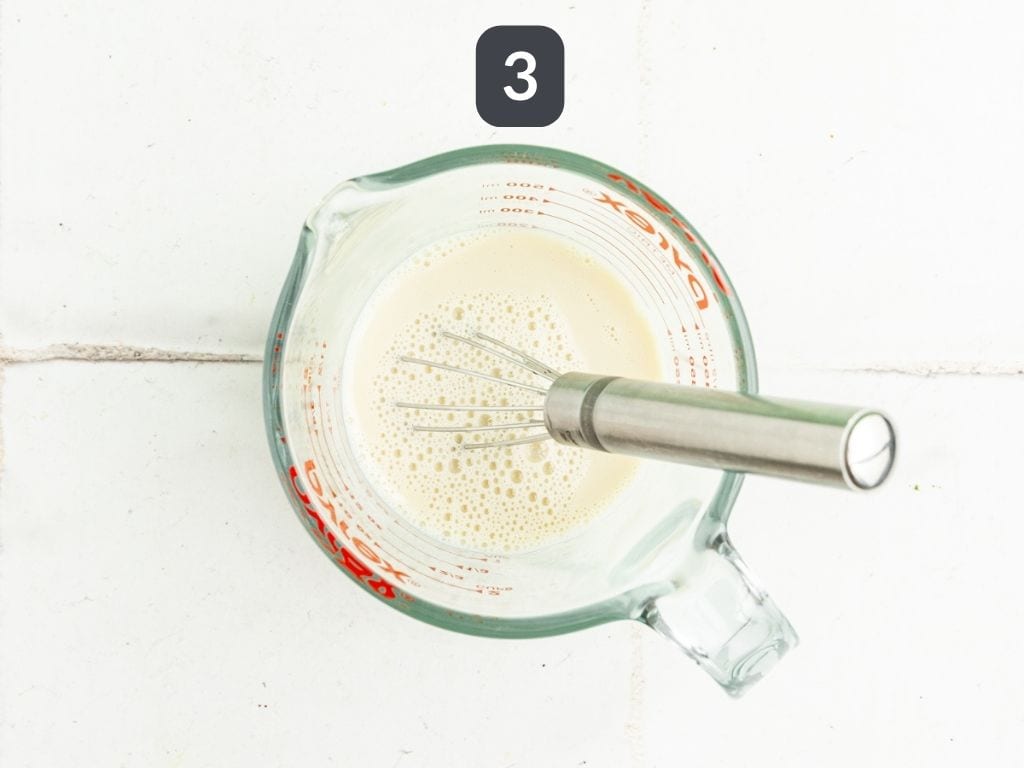 Vegan Iced Matcha Latte Step 3 - whisk the milk and maple syrup.