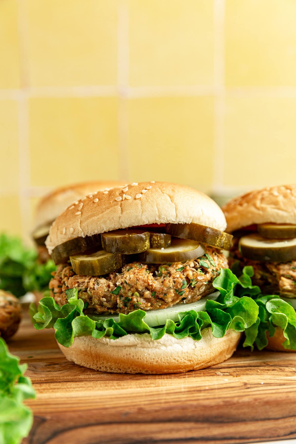 A vegan white bean burger, loaded with lettuce, onion, and pickles.