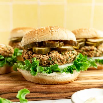 A vegan white bean burger, loaded with lettuce, onion, and pickles.