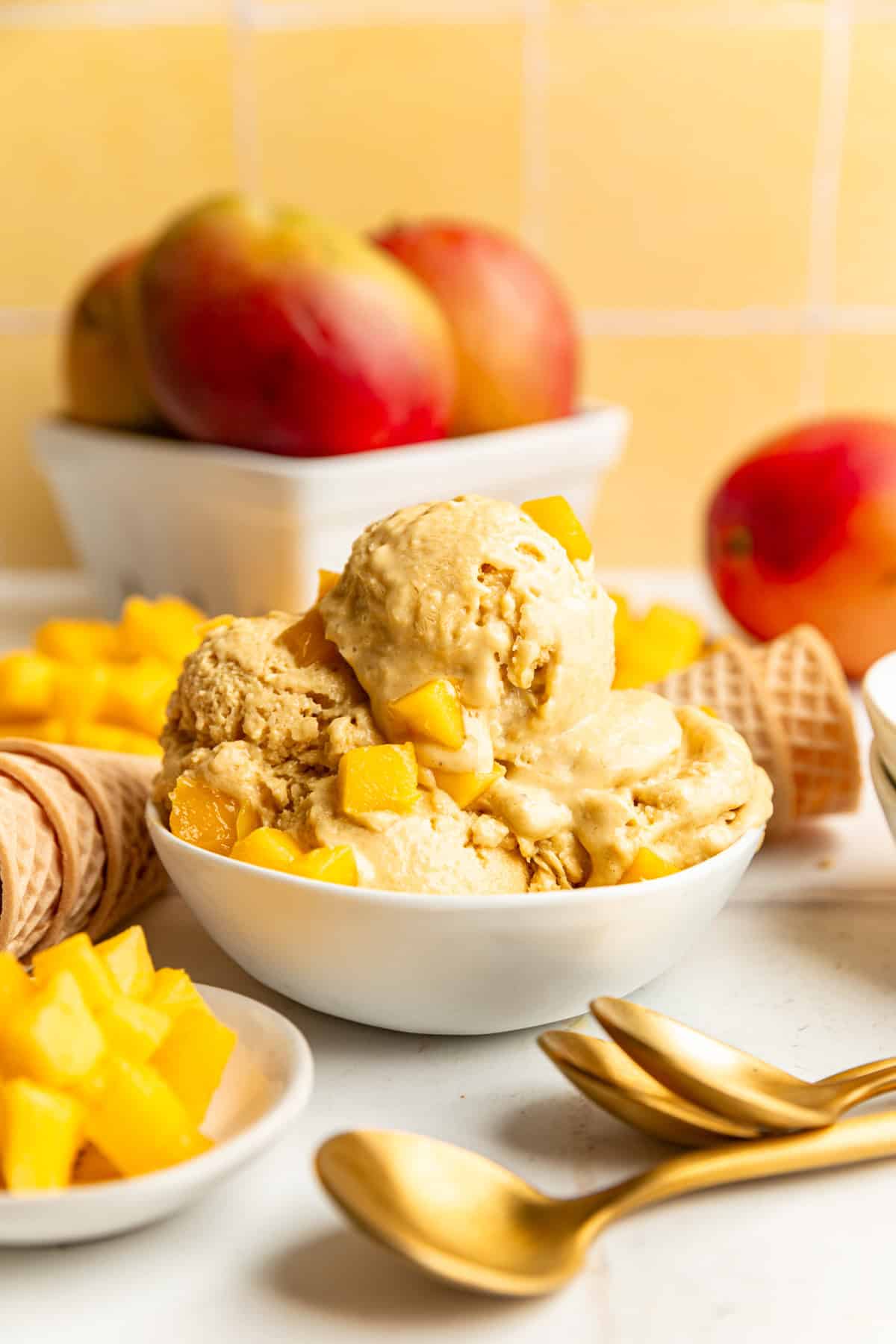 A bowl loaded with many scoops of vegan mango ice cream.