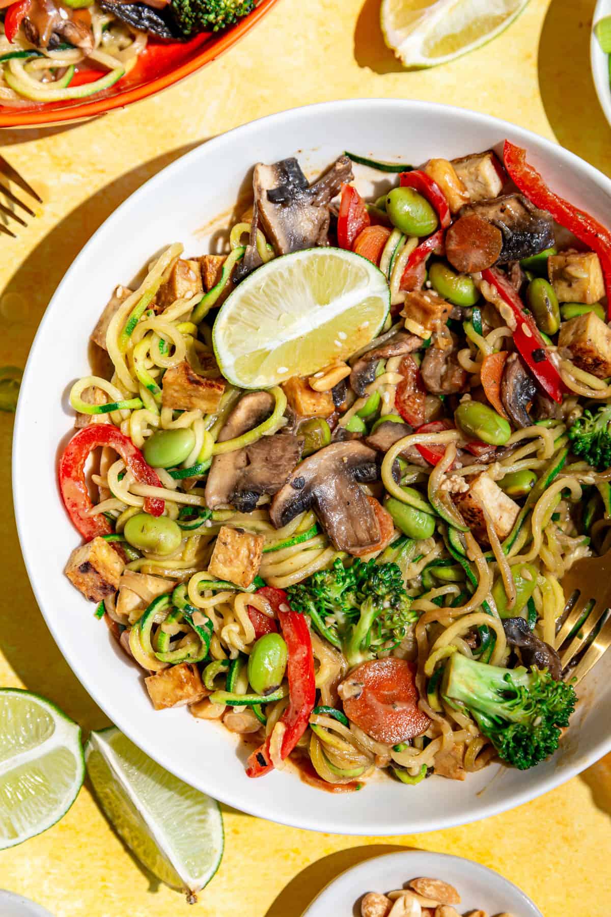 A bowl of zucchini noodle pad Thai, tossed and ready to eat.