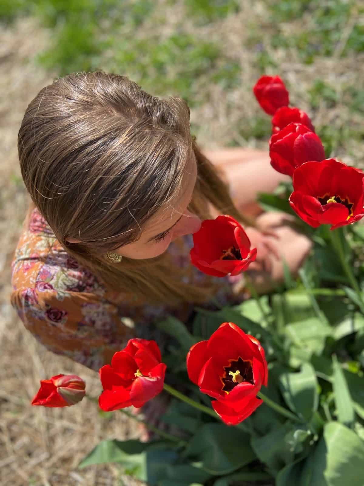 Elizabeth smelling flowers