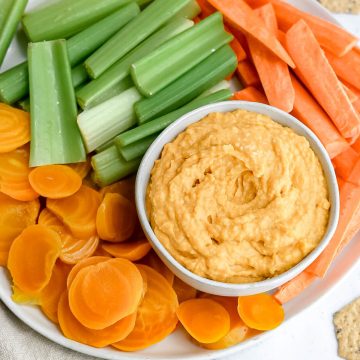 A tray of veggies and sweet potato hummus.