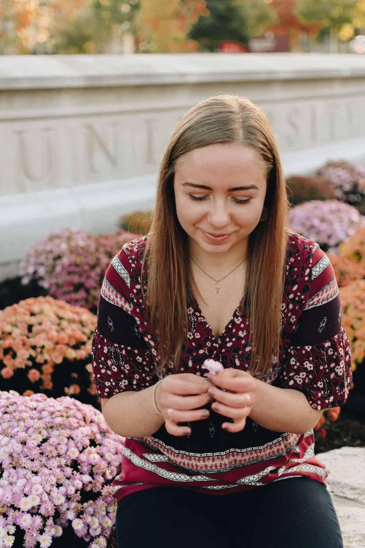 Elizabeth looking at a flower