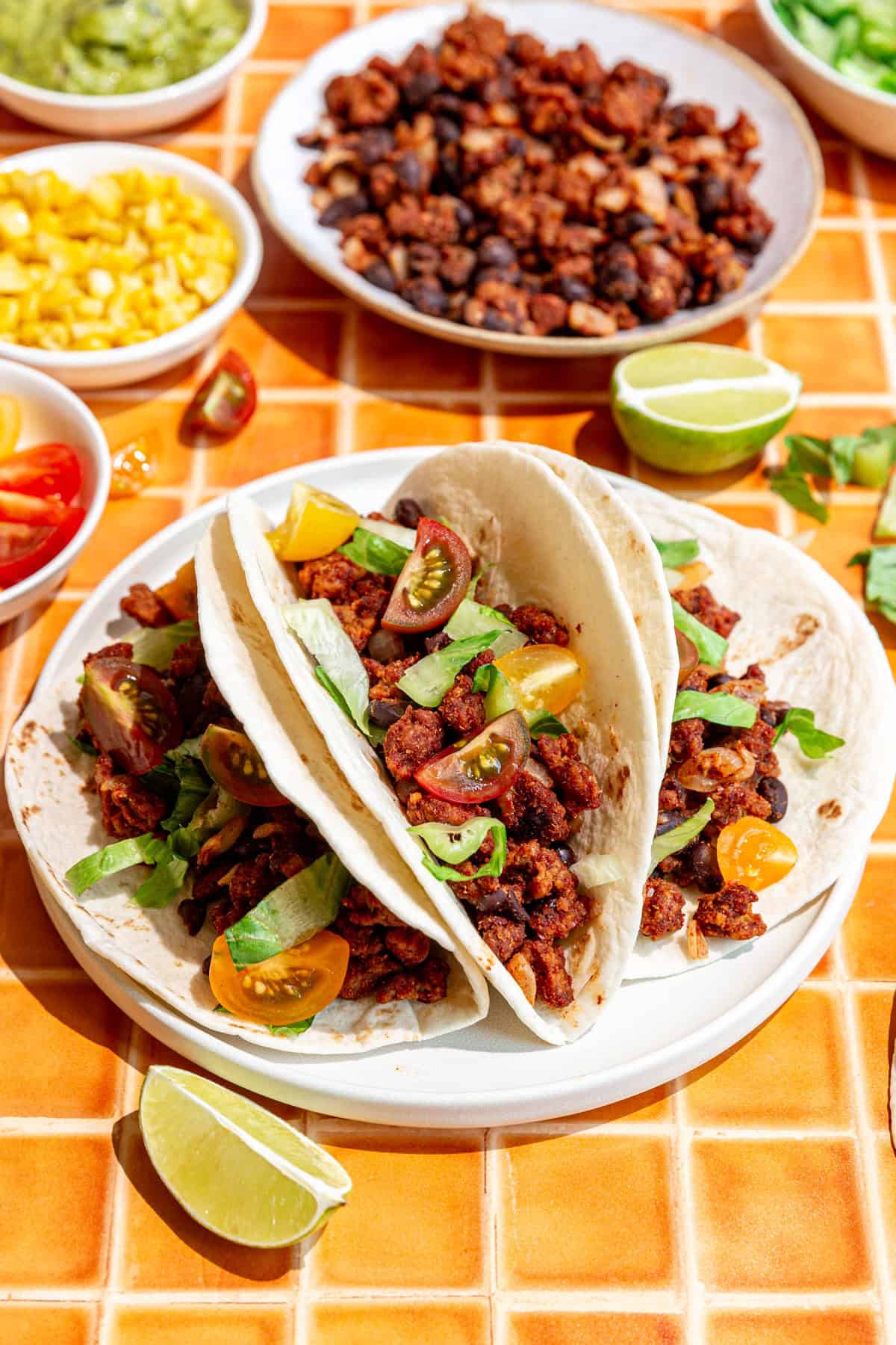 Three seitan tacos on a plate.