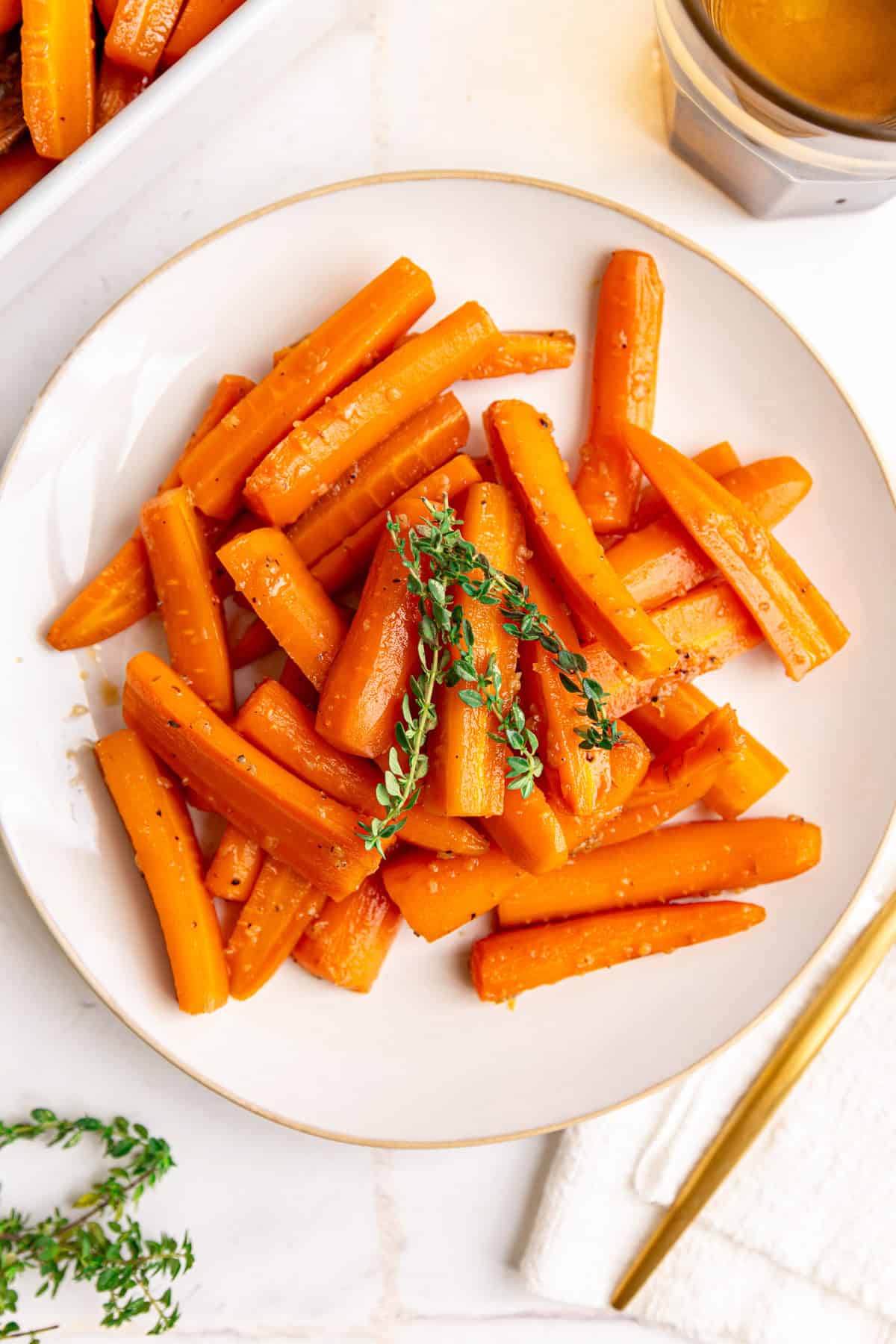 A plate of vegan glazed carrots, with a fork, ready to serve.