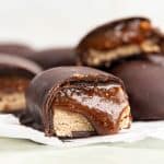 A vegan milky way bar cut in half, with caramel oozing out.