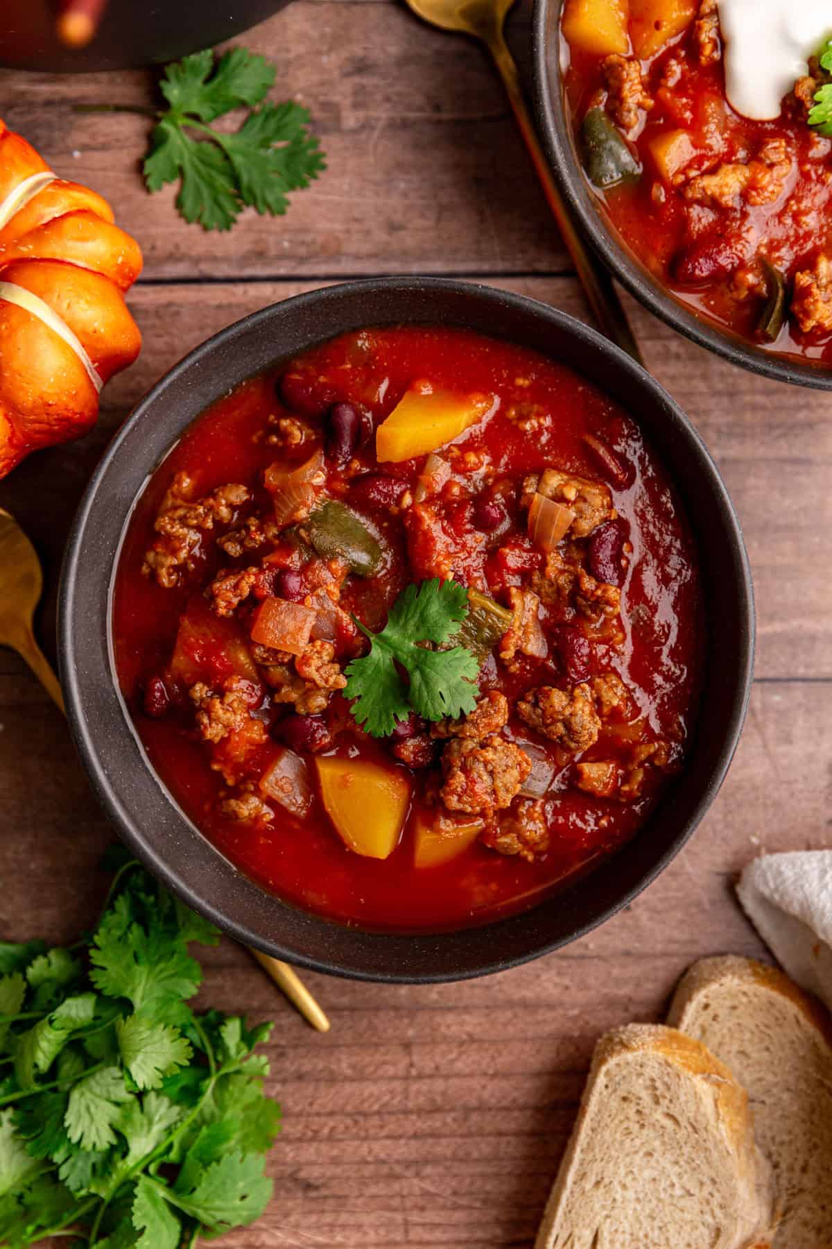 A bowl of Vegan Pumpkin Chili, garnished with cilantro.