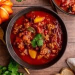 A bowl of Vegan Pumpkin Chili, garnished with cilantro.