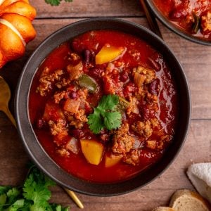 A bowl of Vegan Pumpkin Chili, garnished with cilantro.