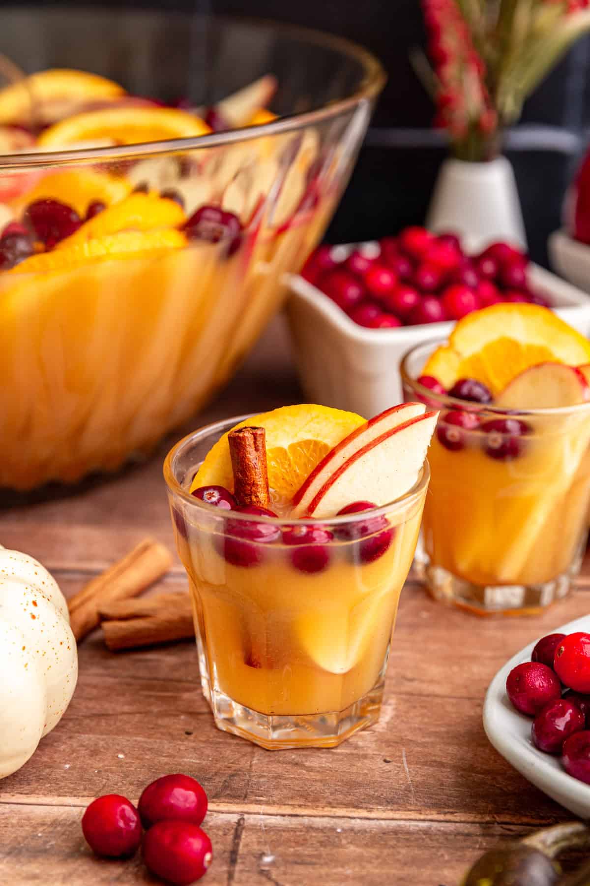 Two glasses of punch, with a punch bowl.