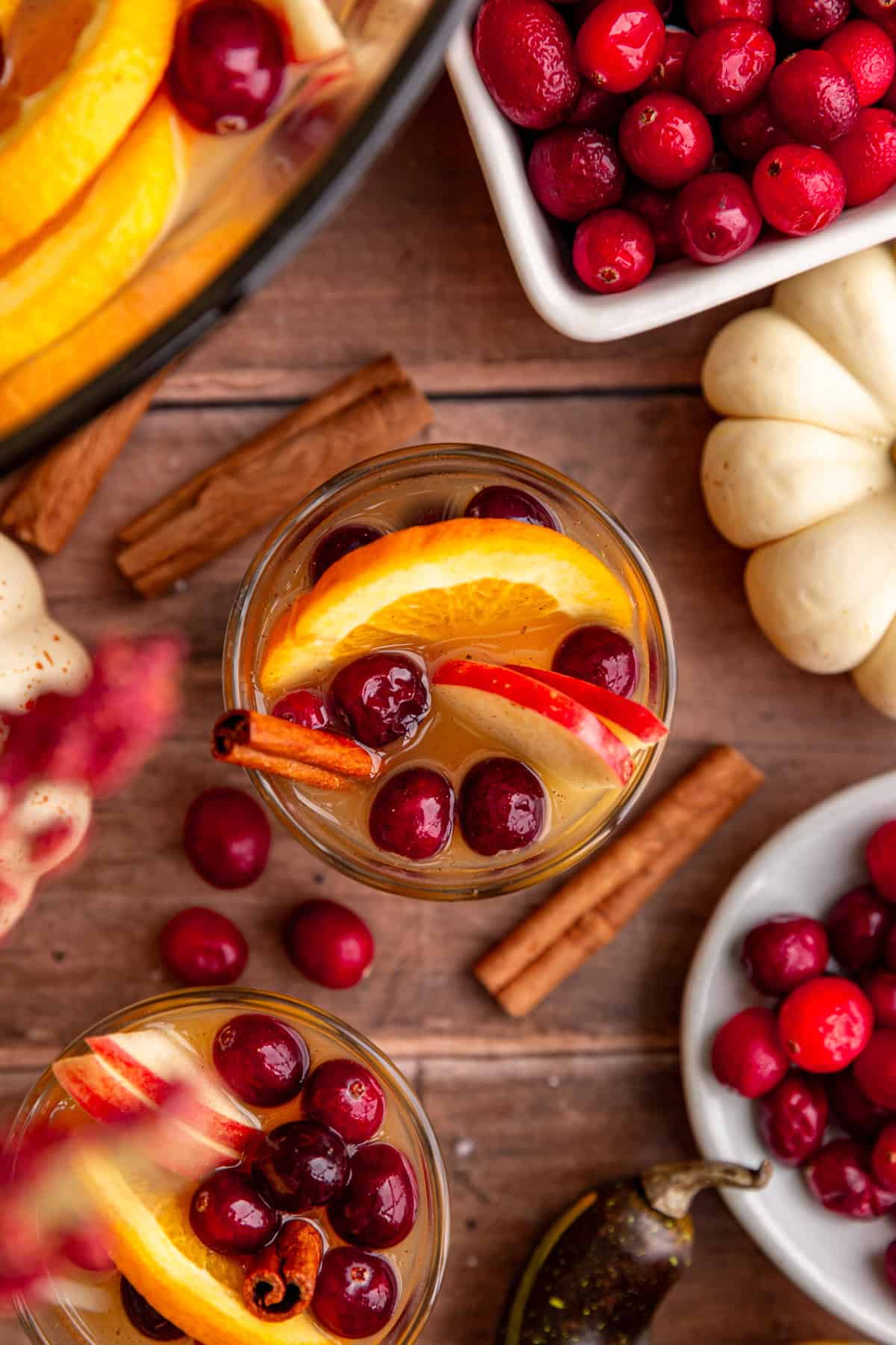 A glass of non-alcoholic Thanksgiving punch, viewed from the top, to see all the fruit in the glass.