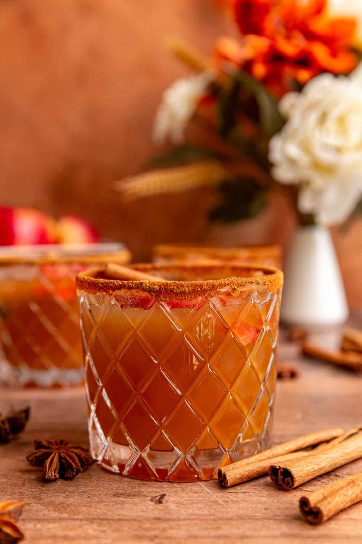 A glass of thanksgiving mocktail, rimmed with cinnamon.