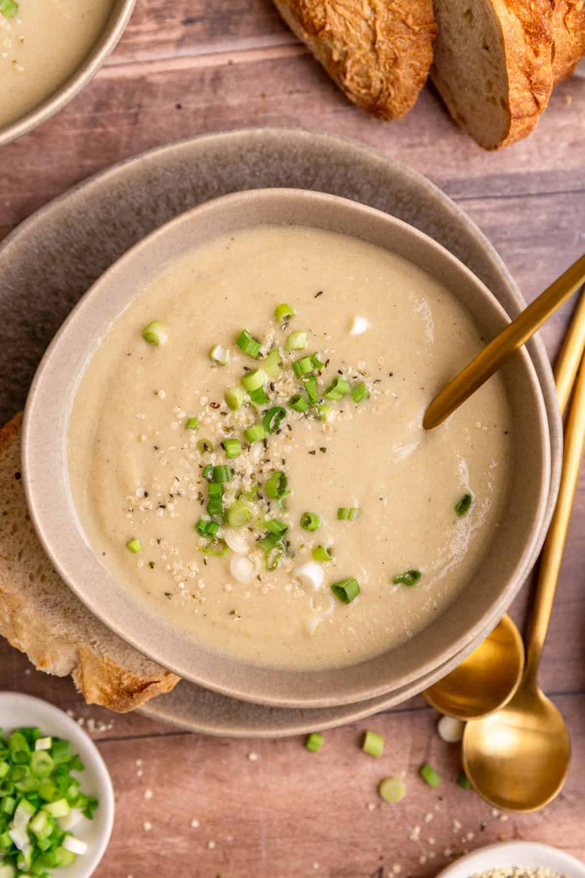 A bowl of vegan celery soup, with a spoon in the bowl.