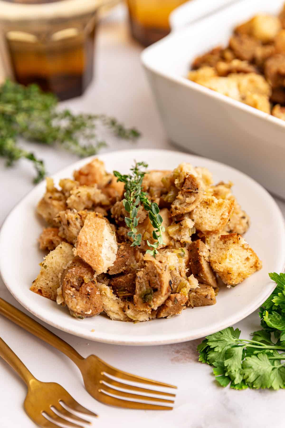 A plate of vegan sausage stuffing, garnished with fresh thyme.
