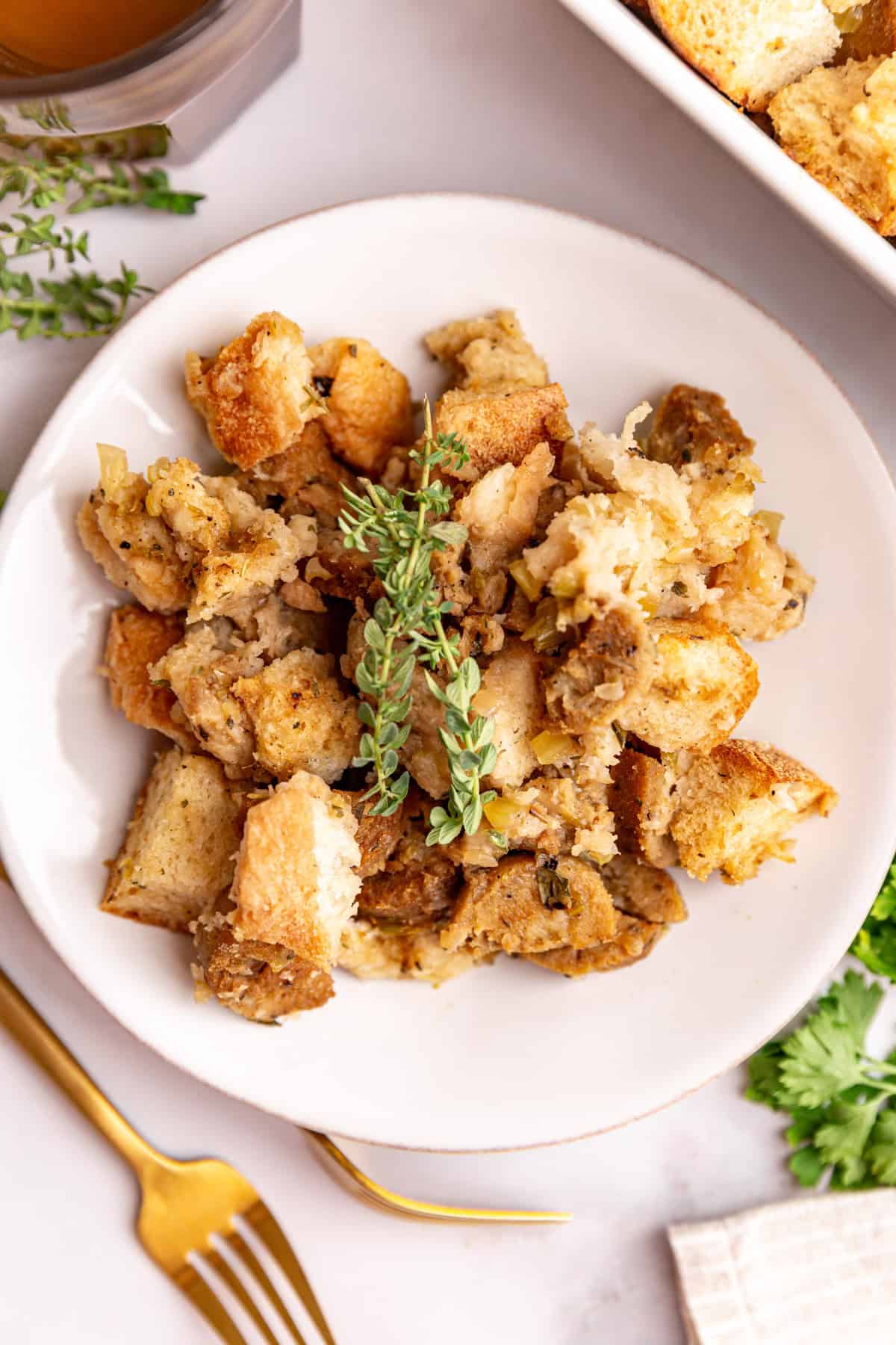 A plate of vegan sausage stuffing, garnished with fresh thyme.
