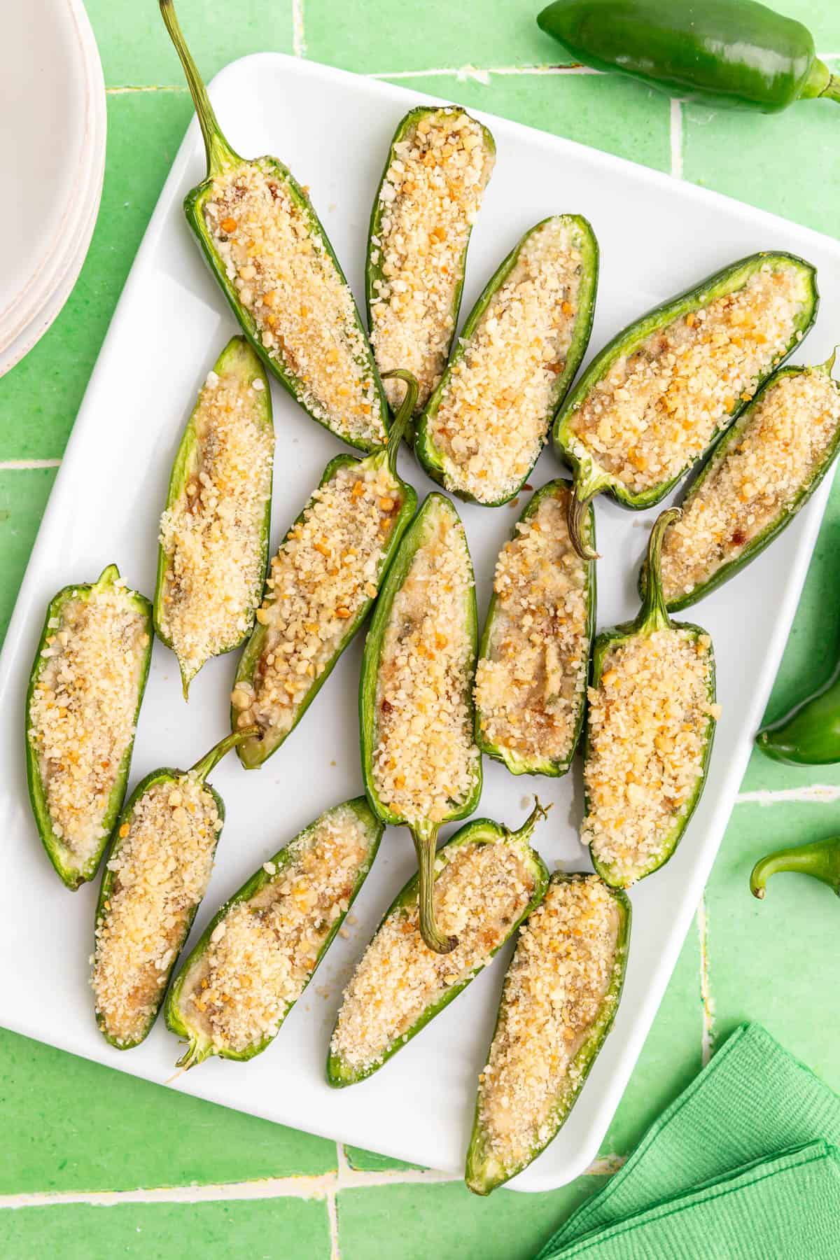A tray of Vegan Jalapeño Poppers, with a few plates and napkins.