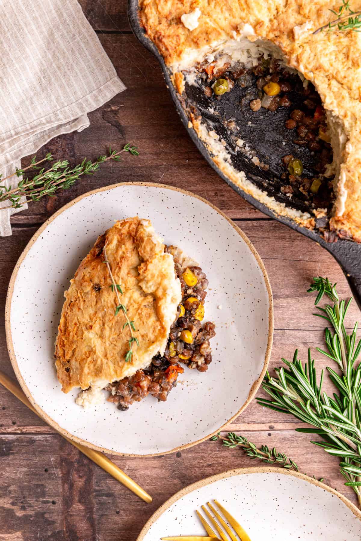 A pan of pie with a scoop taken out and placed in a bowl next to the pan.