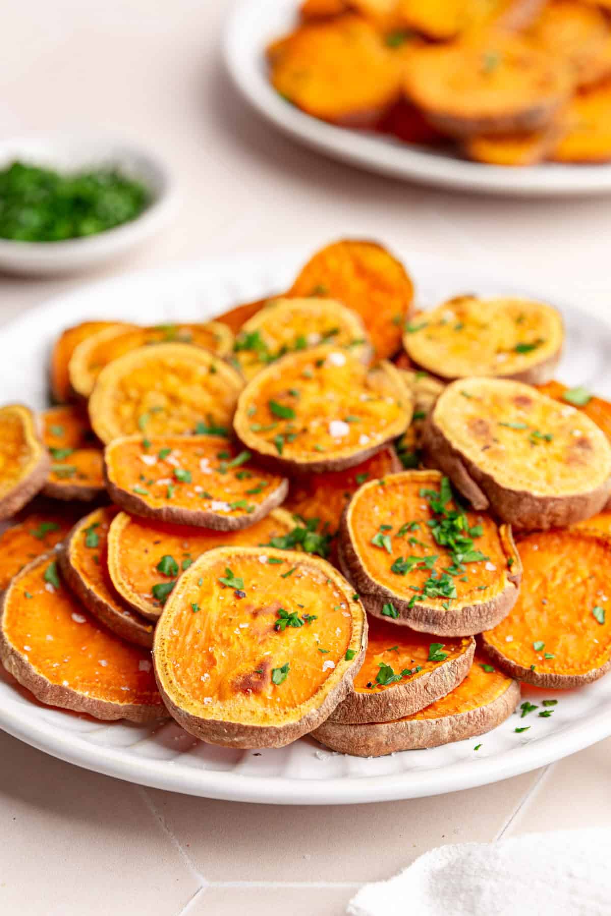 A pile of sweet potato slices on a plate.