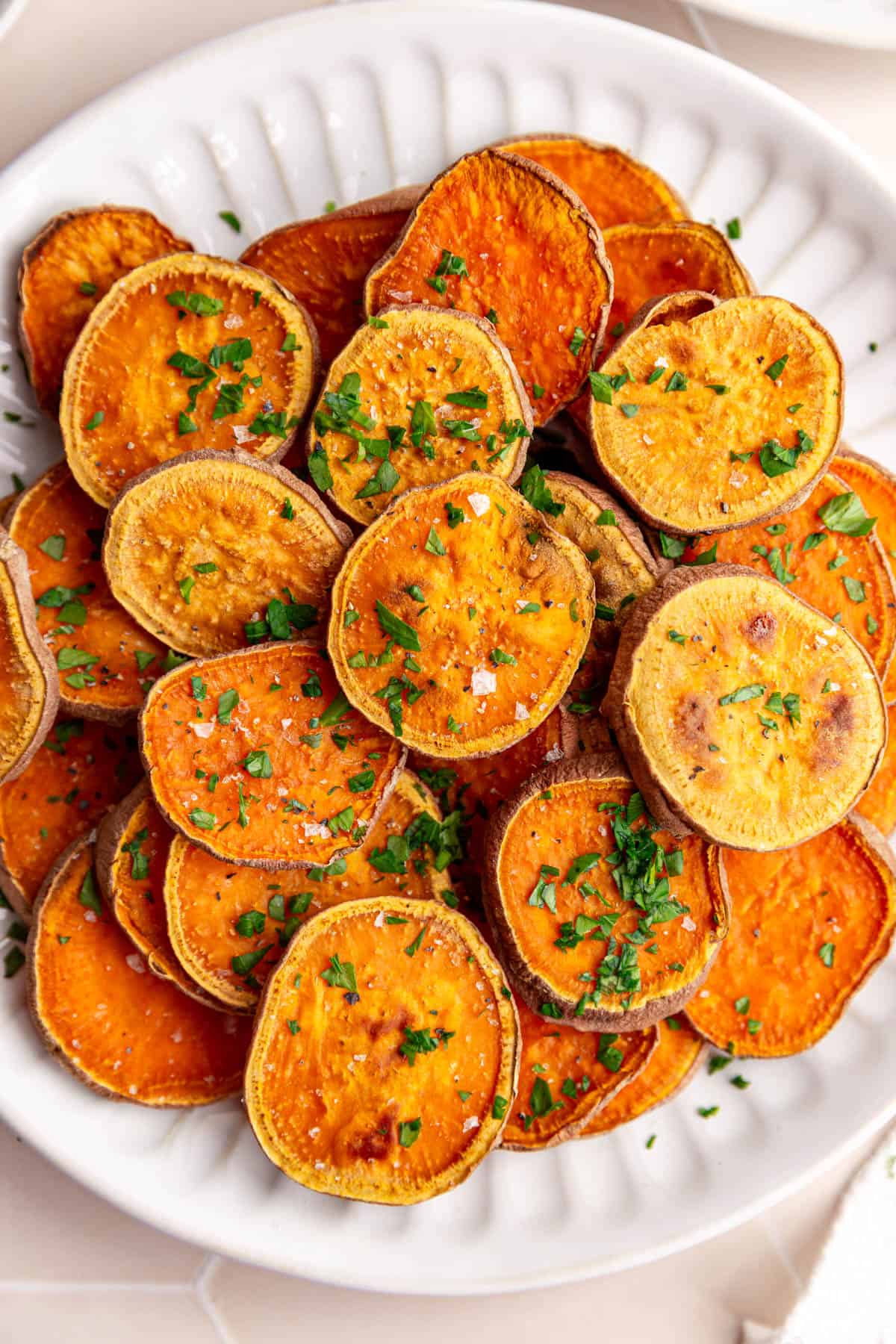 A close up view of baked sweet potato slices to see the golden brown and caramel-like texture.