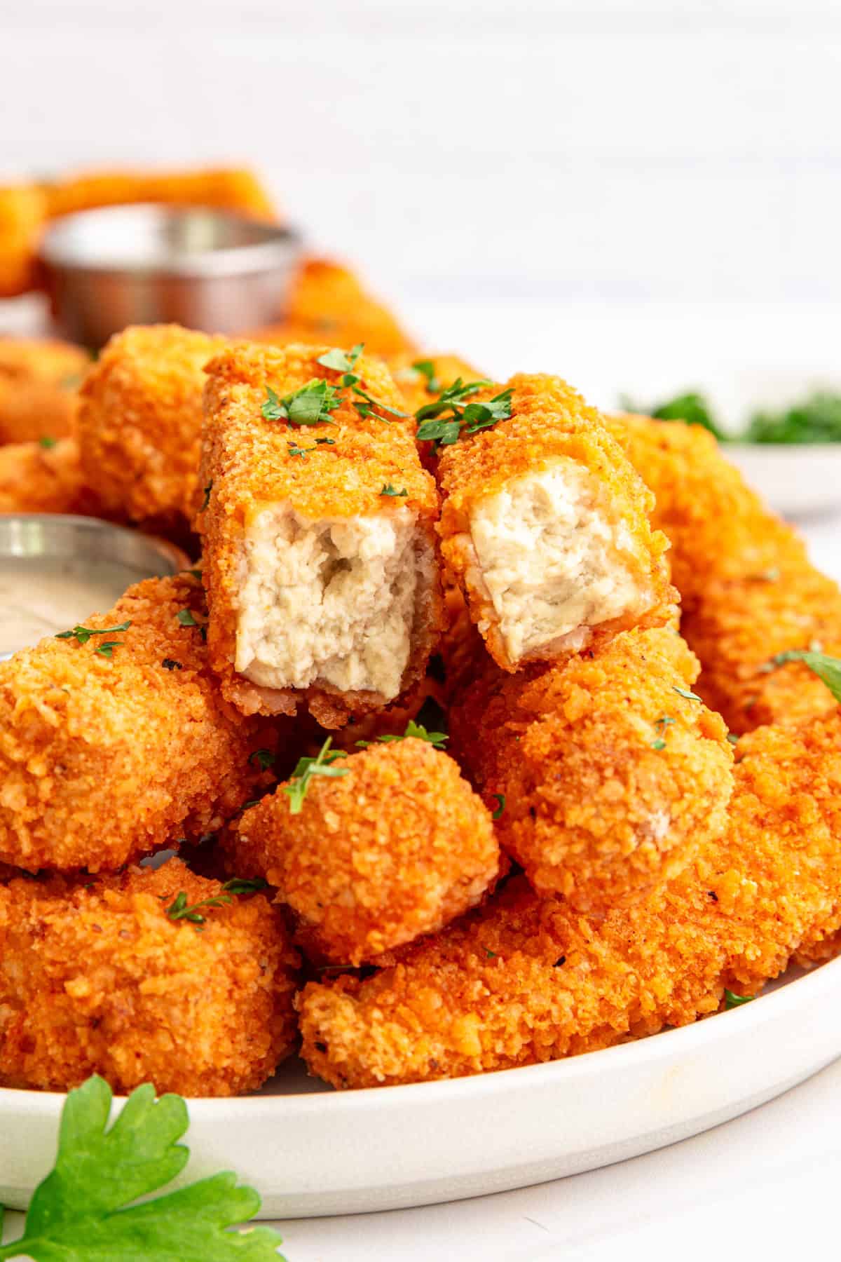 A buffalo tofu wing broken in half to show the nugget-like texture.