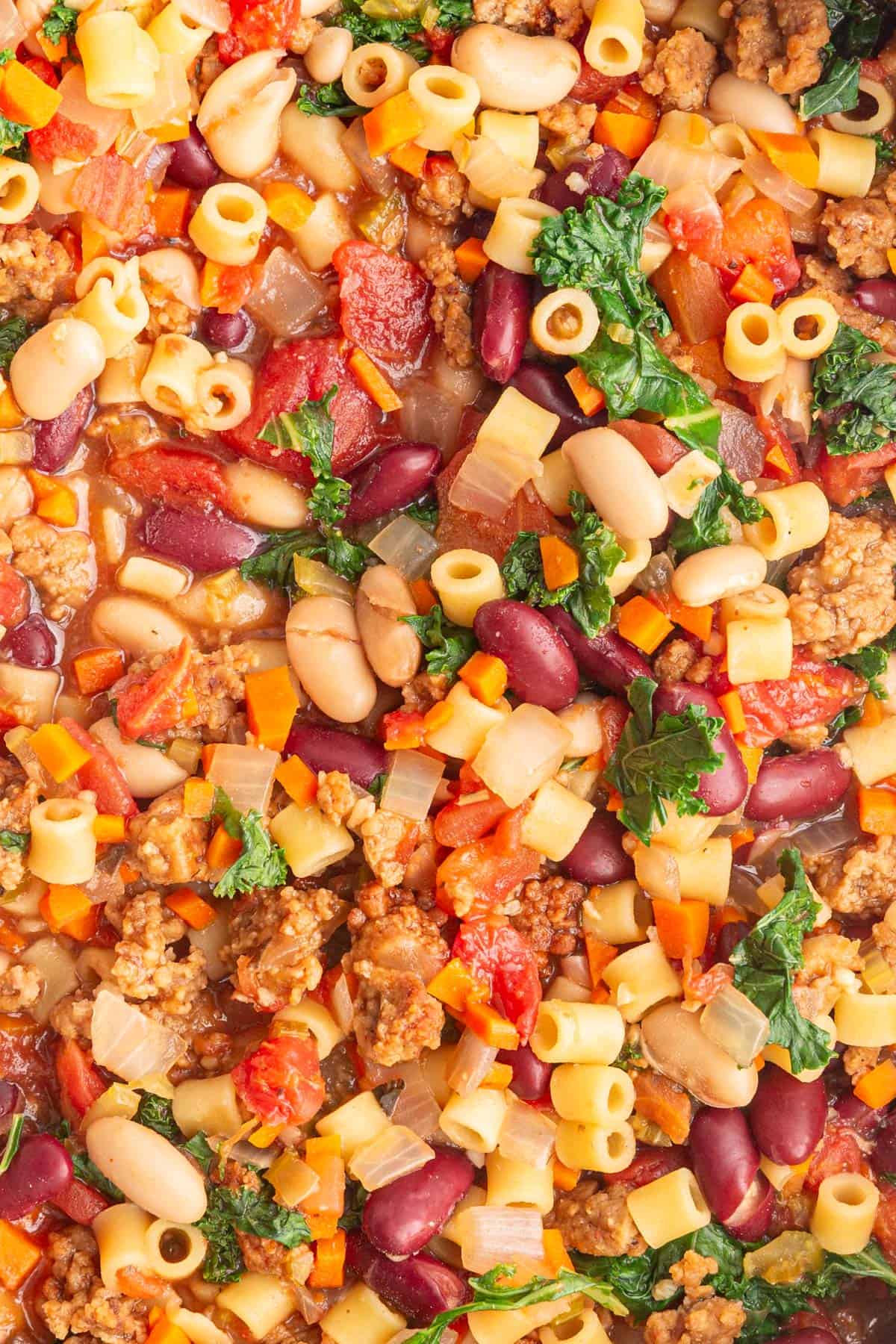 A close up image of the texture of pasta e fagioli soup.