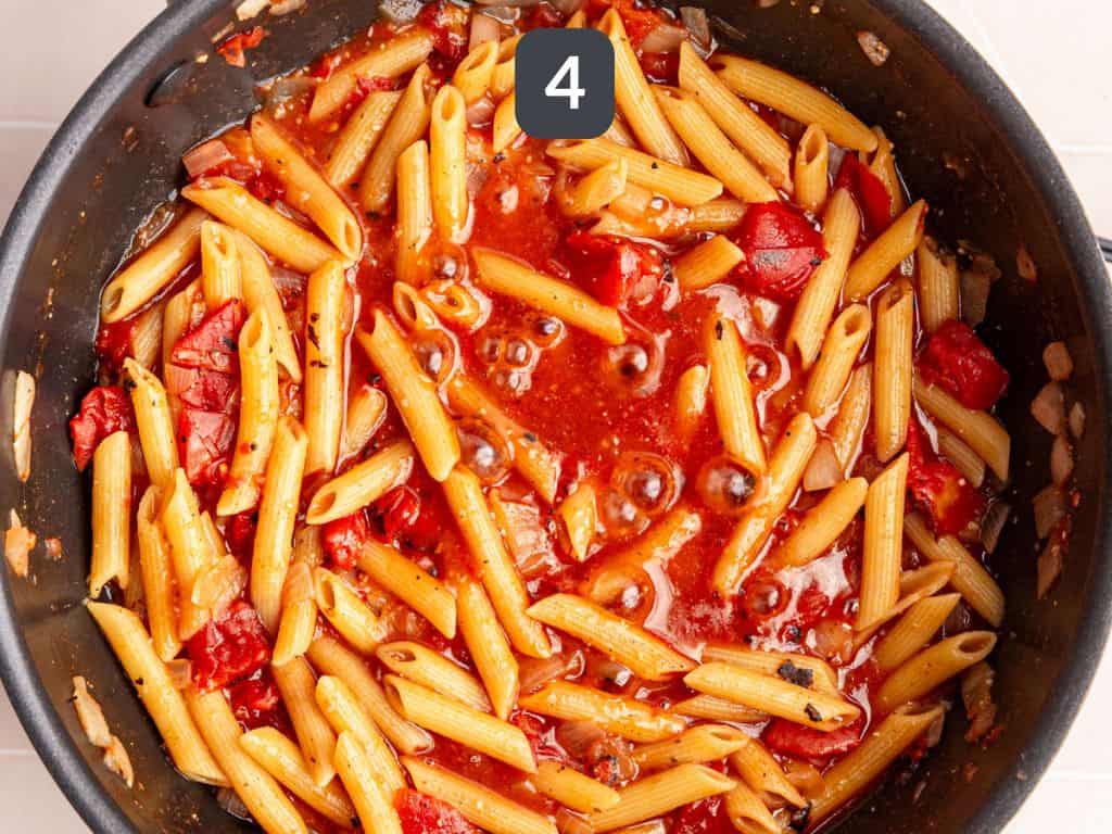 Vegan Cajun Chicken Pasta Step 4 - add the tomatoes and pasta and boil.