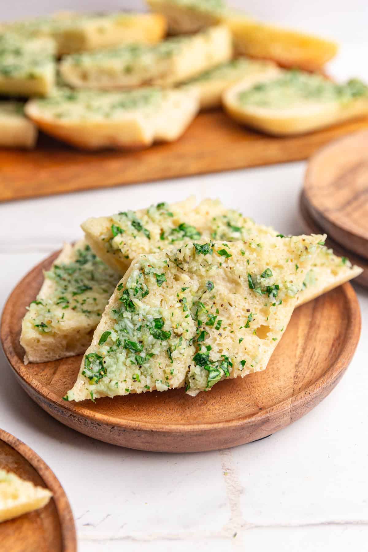 A plate with a pile of garlic bread.