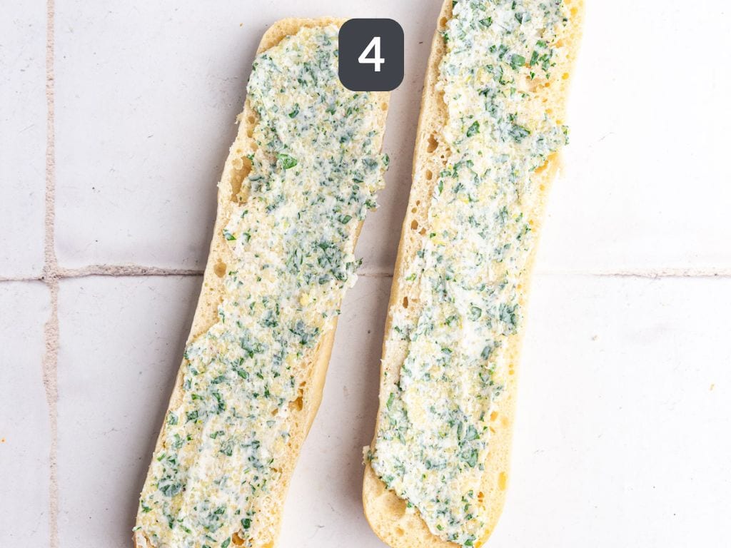 Vegan Garlic Bread Step 4 - spread the garlic mixture evenly on both halves of the baguette.