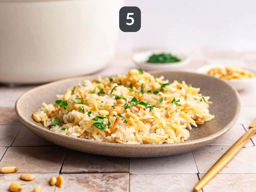 Vegan rice pilaf step 5 - garnish with pine nuts and parsley.