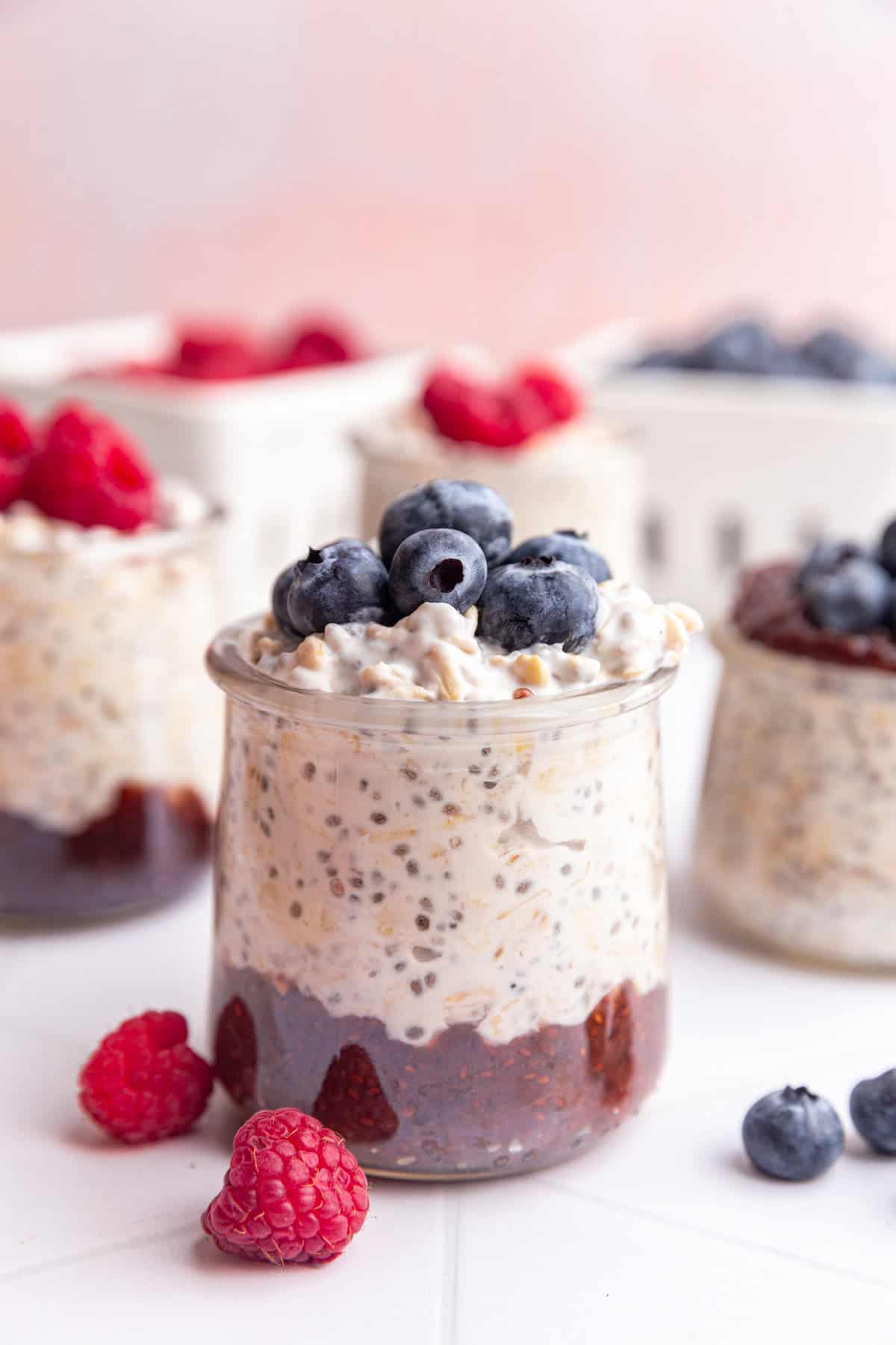 A jar of coconut milk overnight oats topped with blueberries.