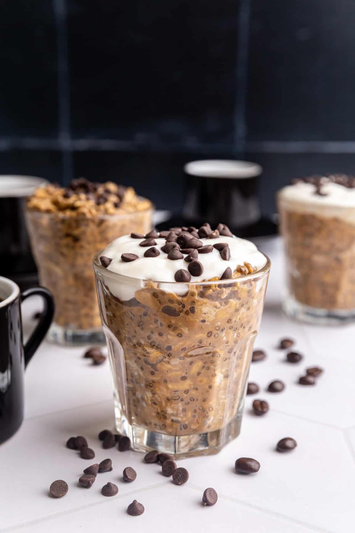A jar of Coffee Overnight Oats, topped with yogurt and chocolate chips.