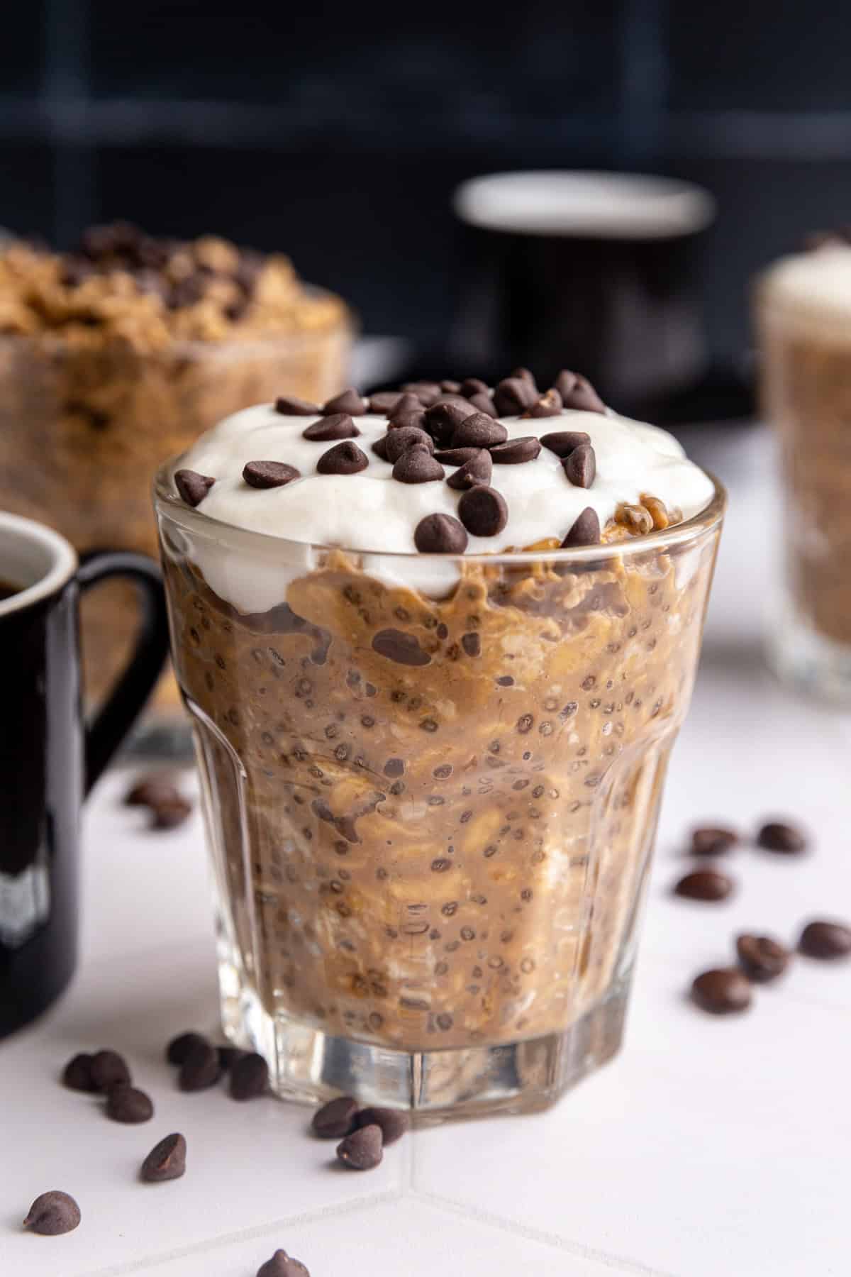 A jar of Coffee Overnight Oats, topped with yogurt and chocolate chips.