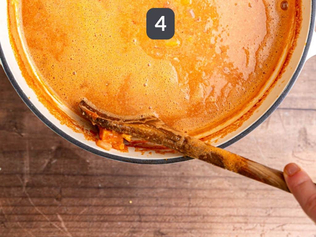 Vegan African Peanut Stew Step 4 - smash the sweet potatoes on the side of the pot.