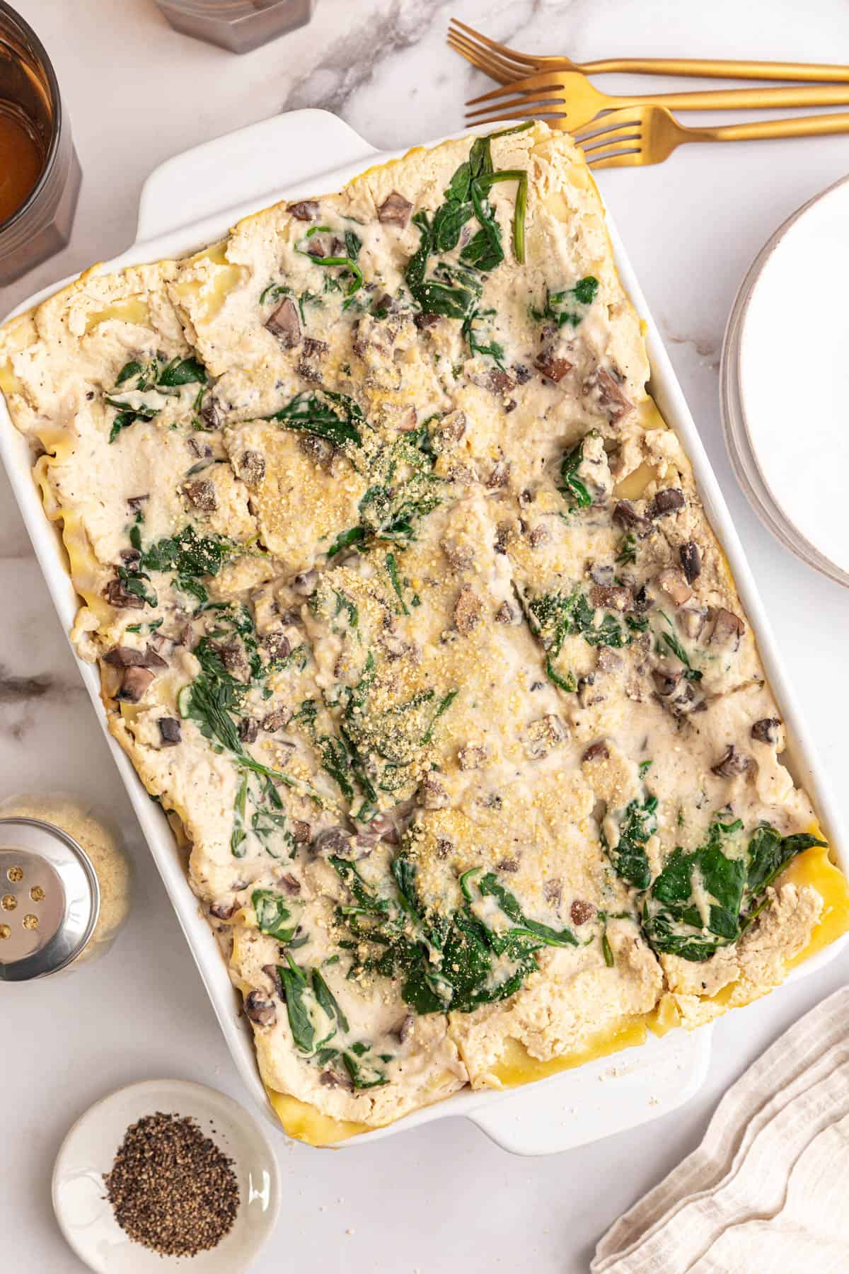 A freshly baked dish of vegan white lasagna, sliced and ready to serve.