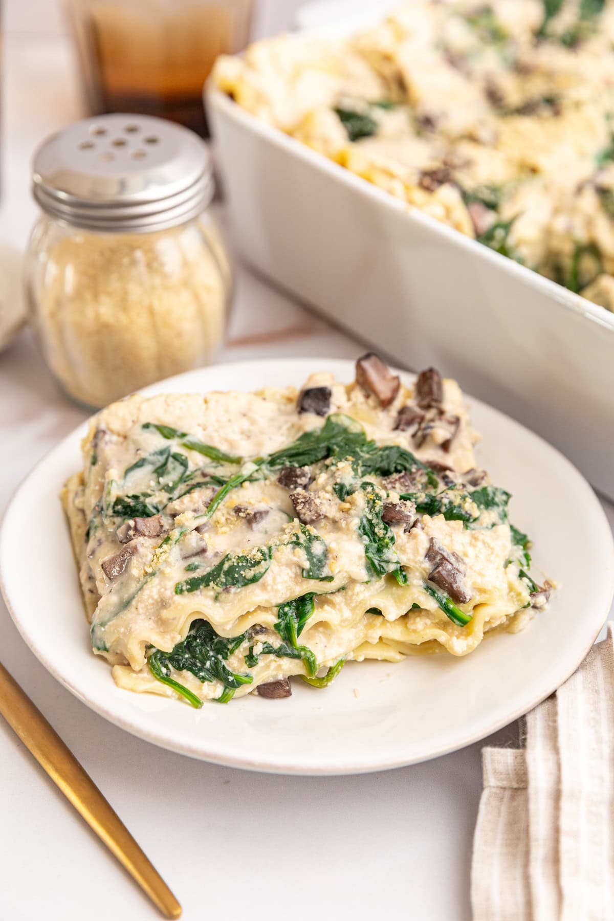 A plate with a serving of white lasagna.