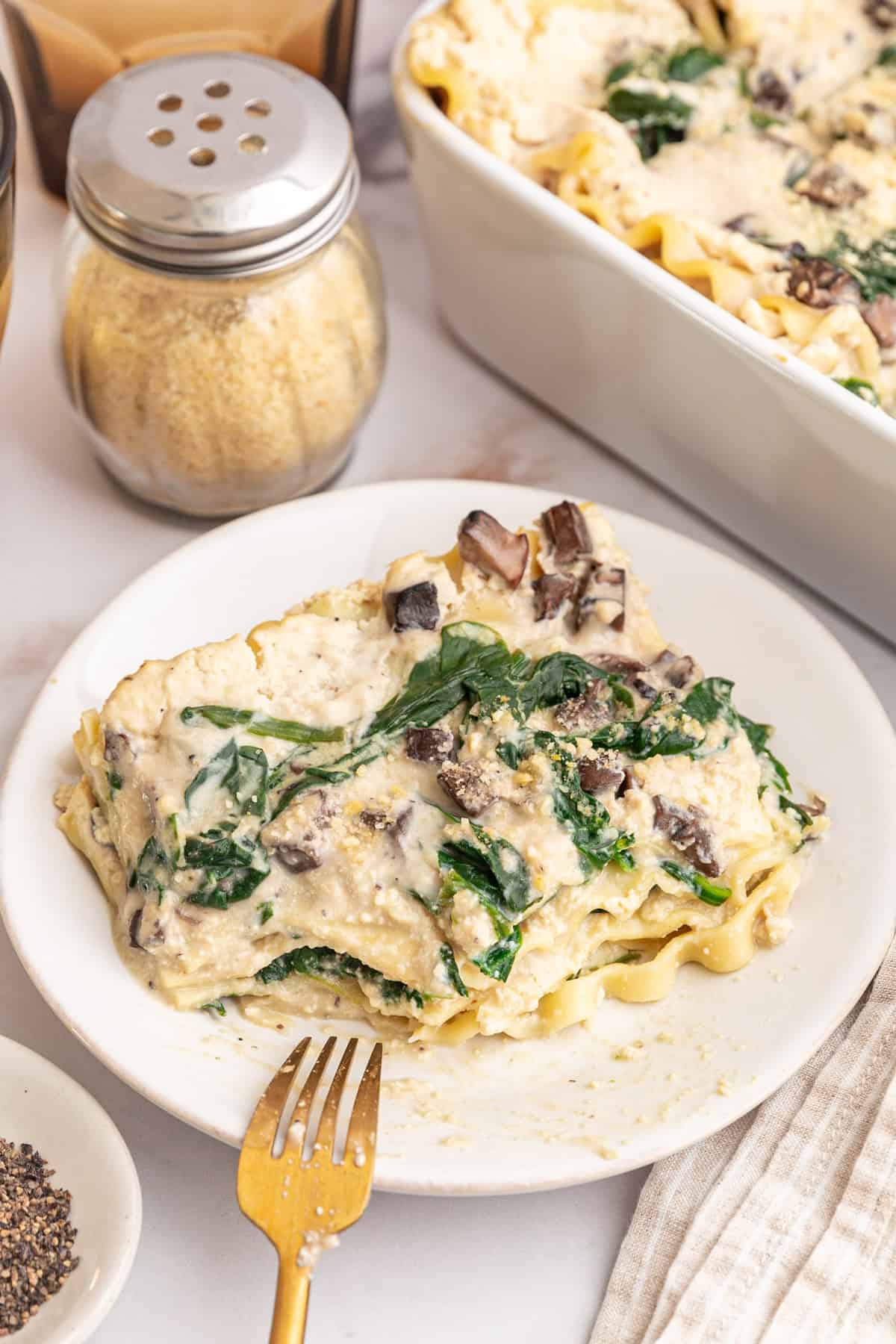 A of white lasagna, with a bite taken out.