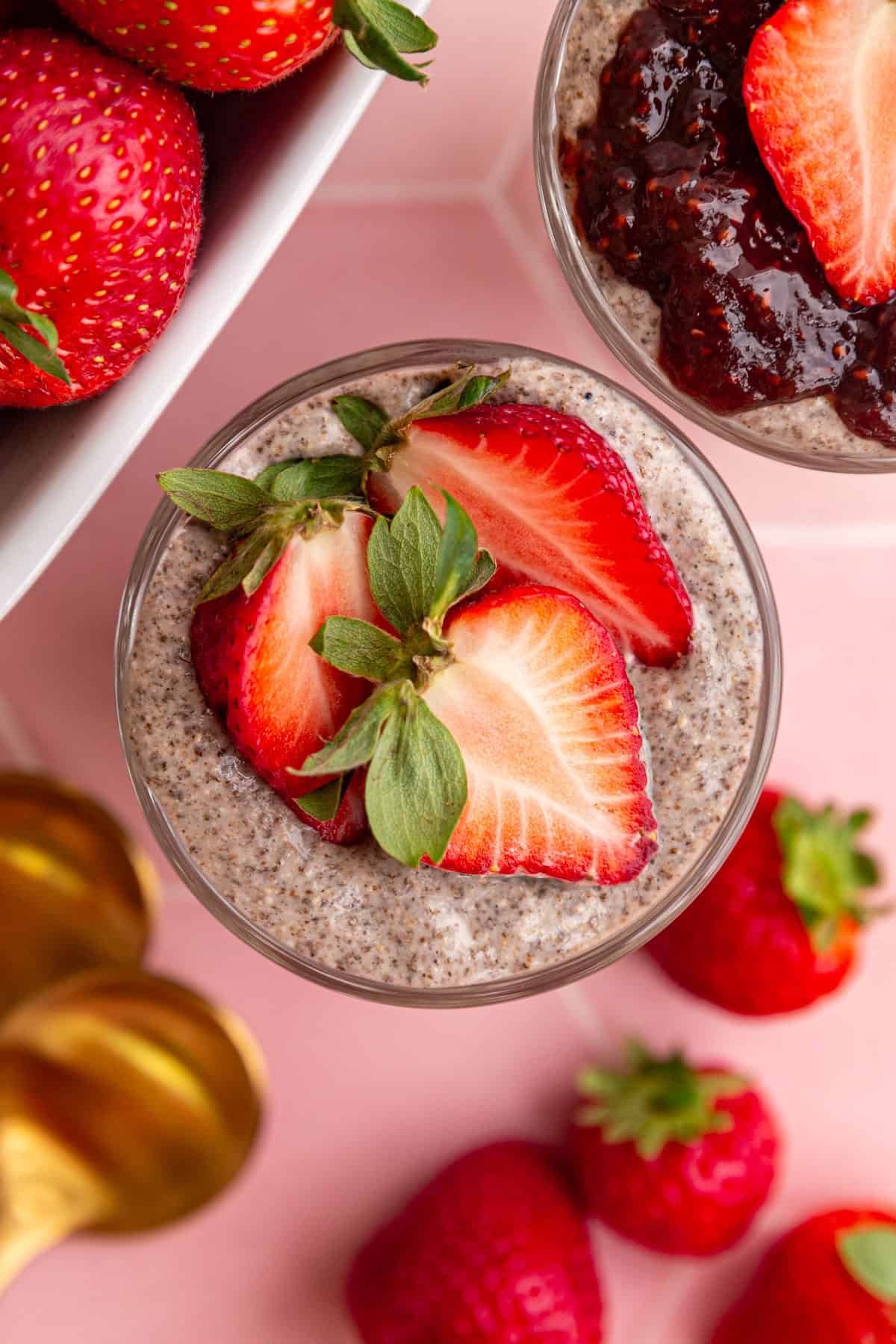 A top down view of a jar of blended chia pudding, topped with strawberries.