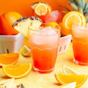 A cinderella mocktail garnished with a pineapple wedge.