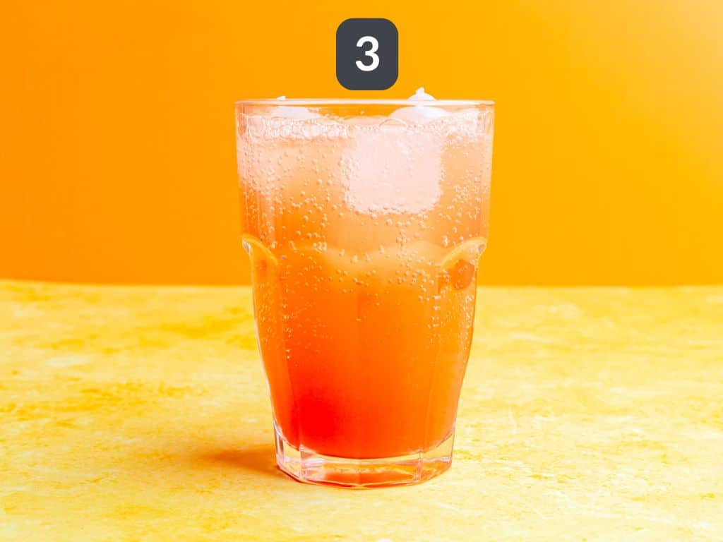 Cinderella mocktail step 3 - add sparkling water.