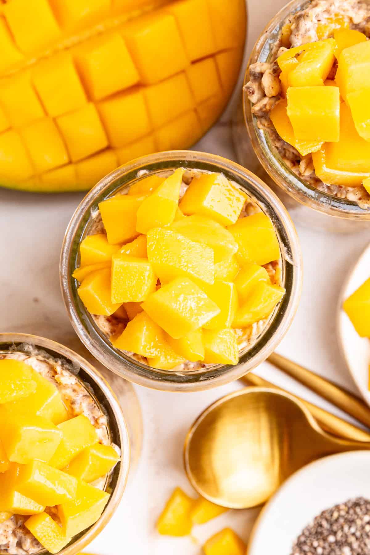 A top-down view of a jar of mango overnight oats.
