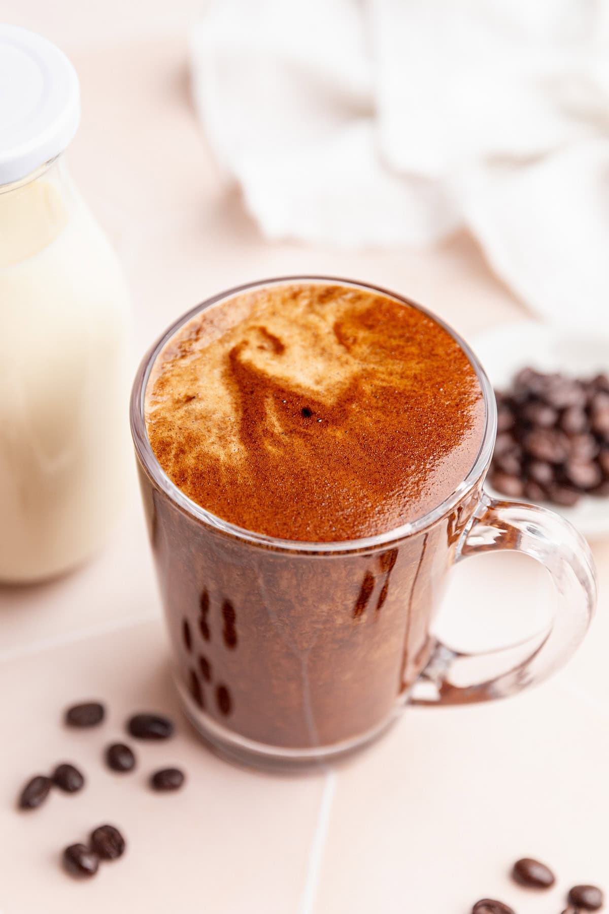 A mug of vegan protein coffee, viewed from the top down.