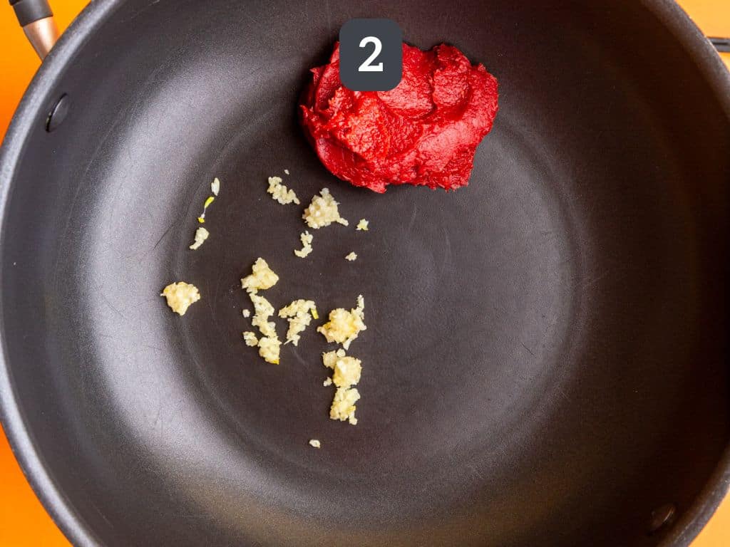 Vegan Vodka Pasta Step 2 - heat the tomato paste and garlic.