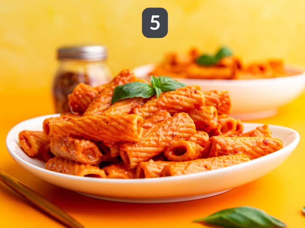 Vegan Vodka Pasta Step 5 - serve with a garnish of fresh basil.